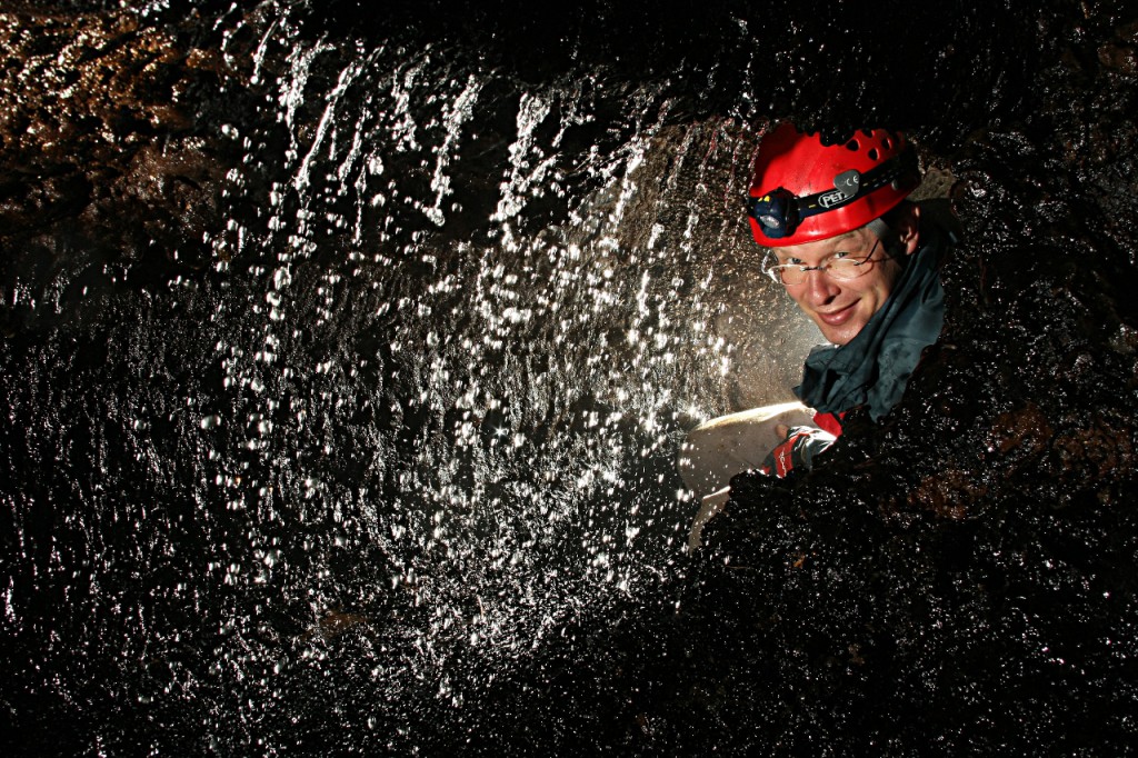 man behind waterfall